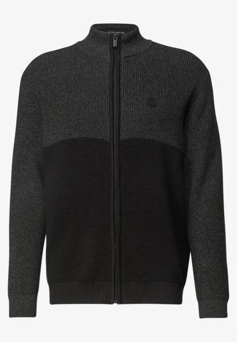 Gilet tricoté bicolore gris foncé et noir, fermeture zippée intégrale et col montant.