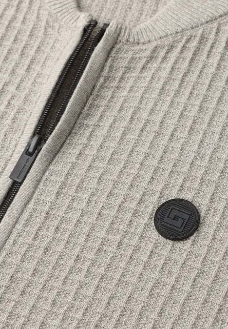 Beige geribbeld breiwerk met zwarte rits en ronde logopatch