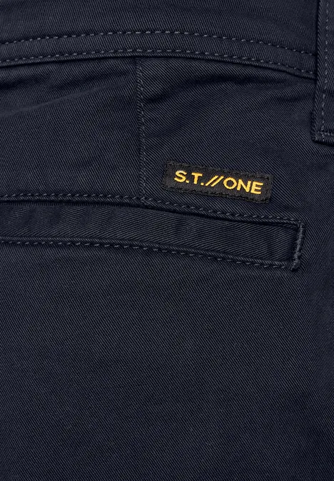 Nahaufnahme einer dunklen Hosentasche mit gelbem S.T.ONE-Label.