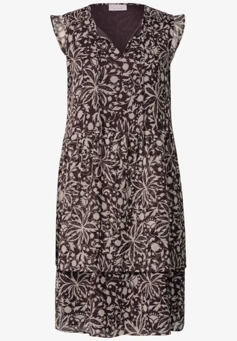 Mouwloze midi-jurk met crème bloemenprint op een donkere achtergrond