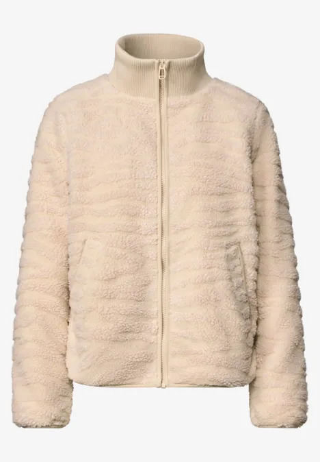 Veste en polaire beige-crème, douce comme un teddy, zippée avec poches latérales.