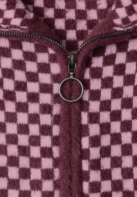 Nahaufnahme eines würfelförmigen karierten Fleece-Stoffes in Rosa und Dunkelrot mit einem Reißverschluss.