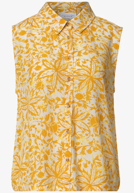 Mouwloze top met geel-wit bloemmotief en klassieke overhemdkraag.