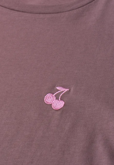 Lila T-Shirt mit kleiner rosa Kirsch-Applikation auf der Brust.
