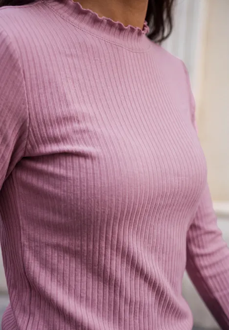 Langarm Shirt mit Turtle Neck pearly rose Nahaufnahme einer Frau in rosa, geripptem Langarmshirt mit Rüschensaum am Kragen.