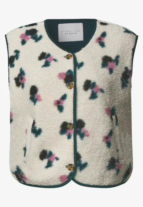 Veste sans manches en polaire sherpa, motif fleuri, encolure ronde et fermeture à boutons.