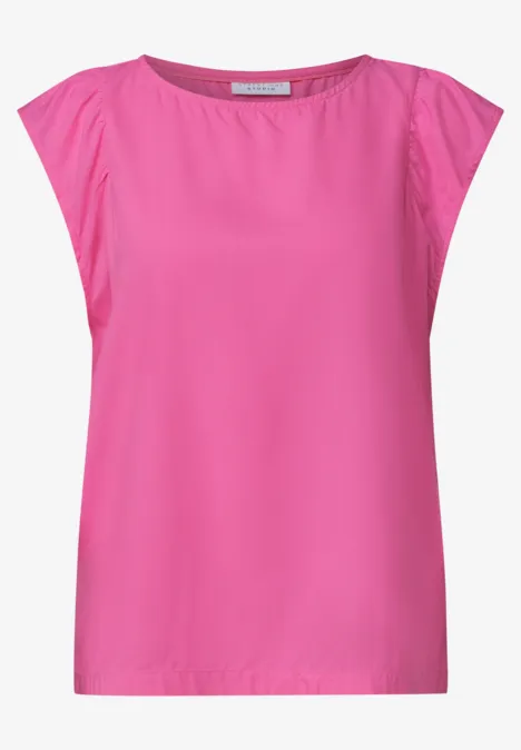 Haut femme sans manches rose vif, coupe droite, col rond et détails légers froncés aux épaules.