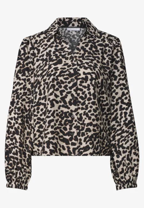 Lichte blouse met beige-zwart luipaardprint, V-hals en lange mouwen.