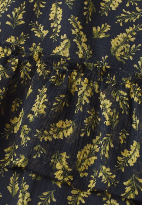 Knielanger Chiffon-Rock mit Print maritime blue Schwarzer Stoff mit gelben Blattmustern und dezent geraffter Taillenpartie.