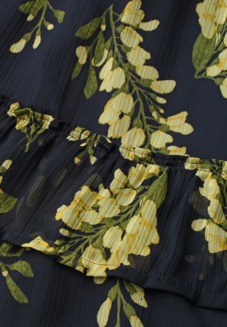 Knielanger Chiffon-Rock mit Print maritime blue Nahaufnahme eines schwarzen Stoffs mit gelbem Blumenmuster und feinen Falten.