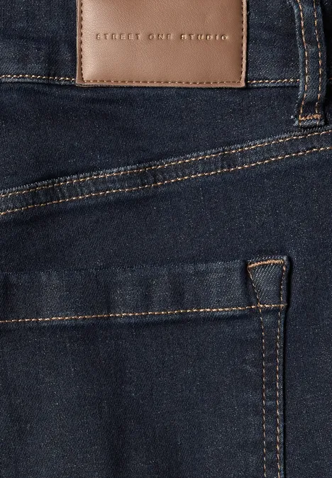 Mid Waist Wide Leg Jeans im Loose Fit rinsed blue washed Nahaufnahme einer dunkelblauen Jeans, Fokus auf Tasche und Lederetikett 'Street One'.