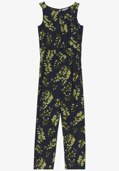 Ein ärmelloser, dunkelblauer Overall mit gelb-grünem Blätterprint.