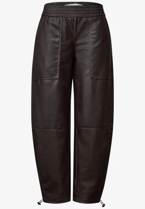 Schwarze Lederhose mit hohem Bund, geraden Beinen, Patchwork-Optik und verstellbaren Schnürbändern am Saum.