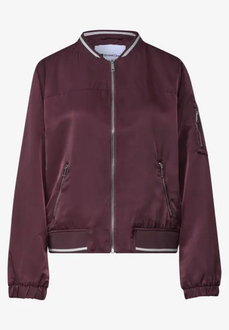 Bordeauxrote Bomberjacke mit Reißverschluss, gerippten Bündchen und seitlichen Taschen.