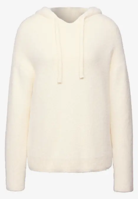 Ein cremeweißer, flauschiger Kapuzenpullover mit Kordeln.