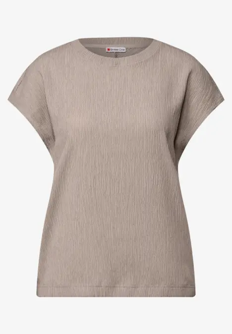 Beiges T-Shirt mit kurzer Ärmel und strukturierter Oberfläche.