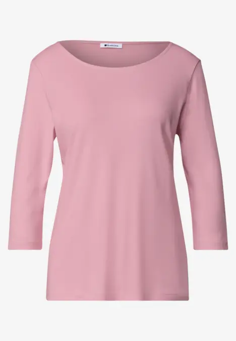 Un haut rose pour femme, manches trois-quarts et encolure ronde, style épuré.