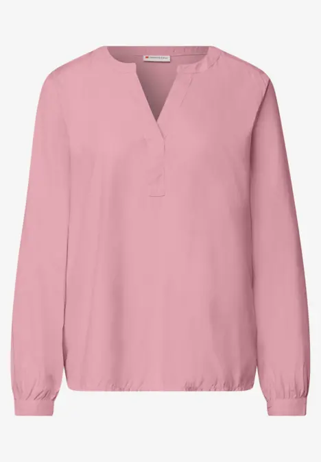 Rosa Bluse mit V-Ausschnitt, langen Ärmeln und elastischen Bündchen.