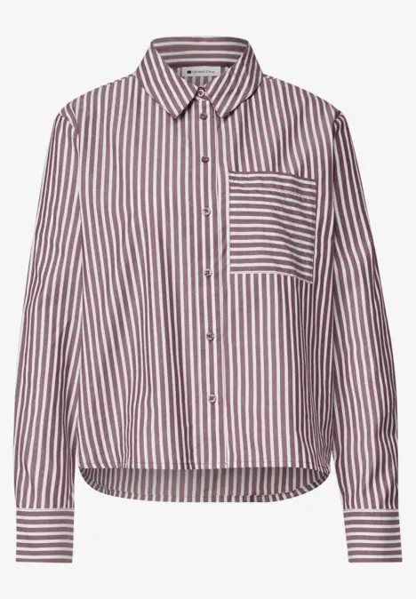 Chemise à manches longues rayée rouge et blanche avec poche poitrine et patte de boutonnage.