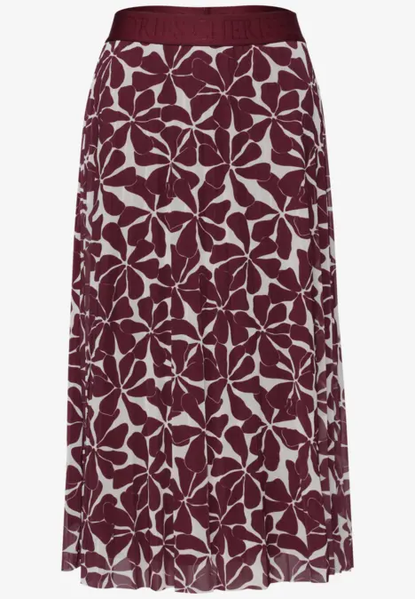 Weinroter, plissierter Midirock mit weißem Blumenmuster.