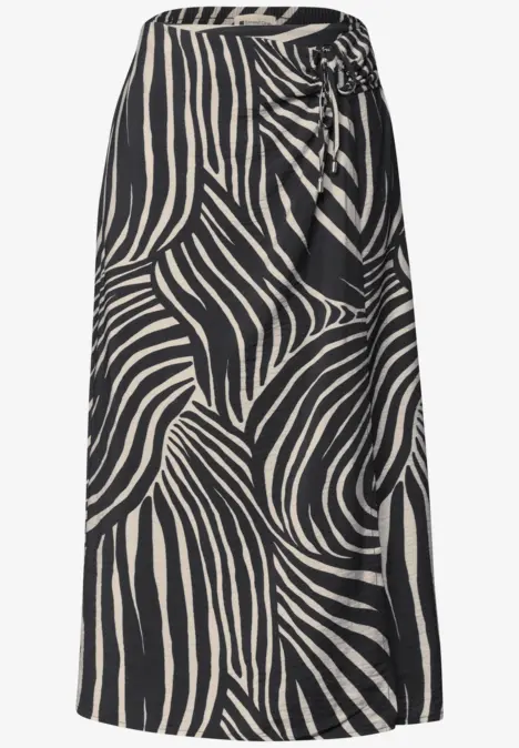 Jupe mi-longue à motif zèbre abstrait noir et blanc avec un nœud latéral à la taille