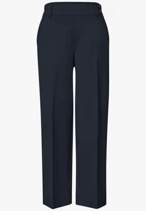 Pantalon de costume bleu foncé, coupe droite avec plis marqués.
