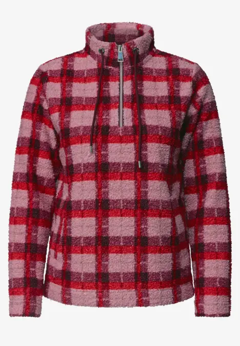 Veste polaire à carreaux rouges et roses, fermeture éclair et col montant.