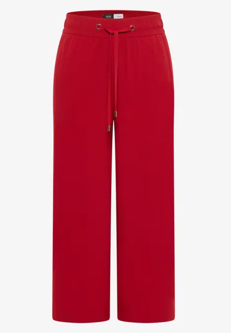 Rote, weite Hose mit elastischem Bund und Tunnelzug, locker geschnitten.