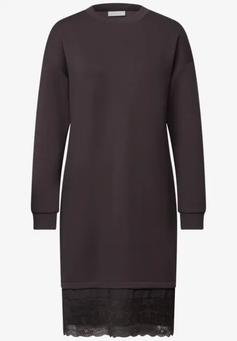 Robe pull noire à manches longues, col rond et dentelle au bas.