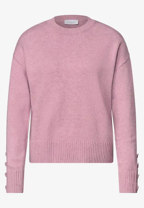 Pull en maille rose à col rond, manches longues, bord-côtes et détails de boutons sur les manches.