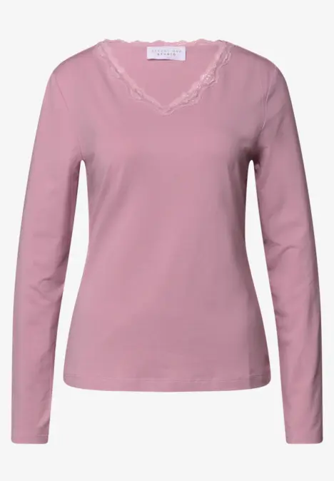T-shirt rose à manches longues pour femme avec col en V et détail en dentelle.