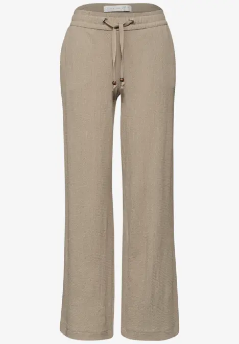 Helle beige Leinenhose mit weitem Bein und Tunnelzugbund aus Kordel.