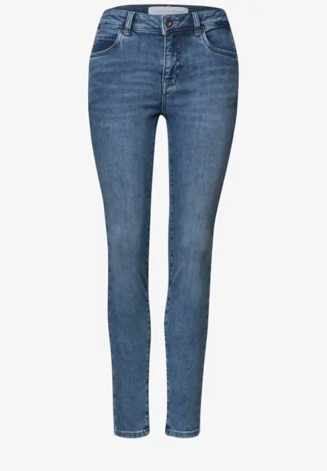 Jean femme slim bleu foncé, taille haute, aspect légèrement délavé.